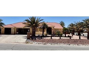 Charming single-story home with a fountain, palm trees, and a tile roof at , Pahrump, NV 89061