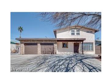 Two story home with a two car garage and covered front entryway at 1806 Renada Cir, North Las Vegas, NV 89030