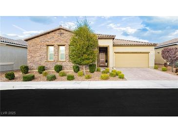 Charming single-story home with stone accents, a two-car garage, and a well-manicured front yard at 2450 Amatrice St, Henderson, NV 89044
