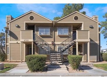 Inviting two-story townhome with dual staircases, classic siding, and manicured landscaping at 2755 Jennydiane Dr, Las Vegas, NV 89121