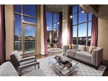 Bright living room with hardwood floors, floor-to-ceiling windows, and views of the Las Vegas strip at 360 E Desert Inn Rd # 807, Las Vegas, NV 89109