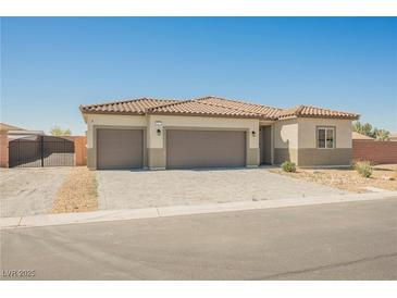 Charming single-story home featuring a three-car garage and a desert-style front yard at 37 Late Harvest Ave, Pahrump, NV 89060