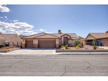 Charming single-story home featuring a three-car garage, desert landscaping, and a tile roof at 5441 Rose Hills St, Las Vegas, NV 89149