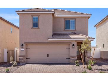 Charming two-story home featuring a two-car garage and a well-manicured front yard at 6233 Blood Lily Ave, Las Vegas, NV 89122