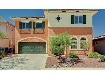 Charming two-story home showcasing a green garage door, shutters and lush landscaping at 7920 Aviano Pines Ave, Las Vegas, NV 89129