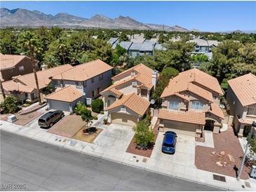 Inviting two-story home featuring desert landscaping and a charming tile roof at 9520 Rancho Palmas Dr, Las Vegas, NV 89117