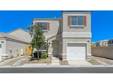 Inviting two-story home featuring a one car garage and manicured front yard at 10078 Delicate Dew St, Las Vegas, NV 89183