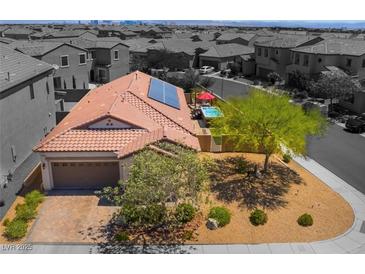 Charming home with a red tiled roof, solar panels, and a well-maintained front yard with a beautiful pool at 184 Cullerton St, Las Vegas, NV 89148