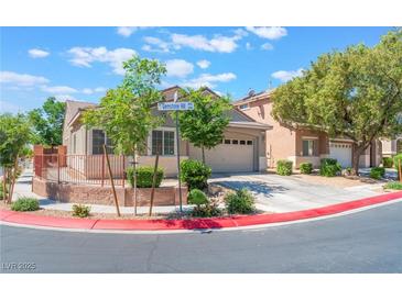 Charming single-story home showcasing a well-manicured front yard and a two-car garage at 329 Gemstone Hill Ave, North Las Vegas, NV 89031