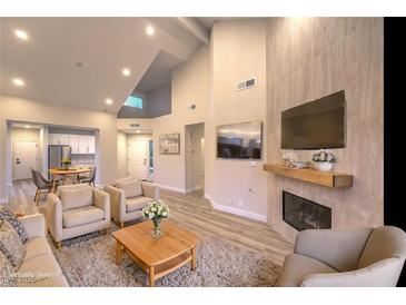 Bright living room featuring hardwood floors, a fireplace, and ample seating at 5010 Crooked Stick Way, Las Vegas, NV 89113