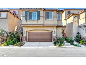 Inviting two-story home featuring an attached two-car garage and well-manicured landscaping at 10735 Galveston Bay St, Las Vegas, NV 89179
