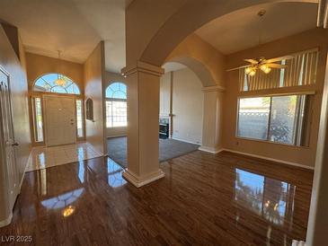Inviting living room featuring hardwood floors, archways and a well-lit entrance at 3136 Jane Austin Ave, North Las Vegas, NV 89031
