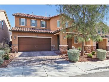 Charming two-story home with a brick-accented facade, a two-car garage, and landscaped front yard at 334 E Neal Ave, Las Vegas, NV 89183
