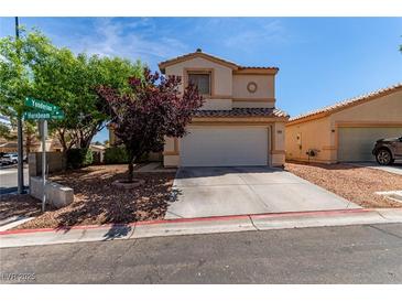 Charming home featuring a two-car garage, complemented by drought-resistant landscaping and mature trees at 7912 Horn Beam Ct, Las Vegas, NV 89131