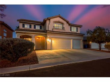 Charming two-story home with a three-car garage, desert landscaping, and a welcoming entrance, illuminated by warm lights at , Las Vegas, NV 89117