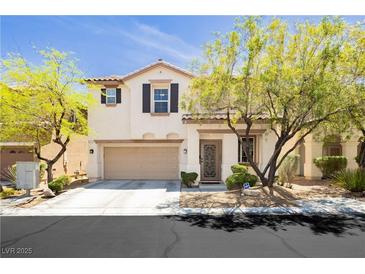 Charming two-story home with desert landscaping, an attached two-car garage and a welcoming front porch at , Las Vegas, NV 89178