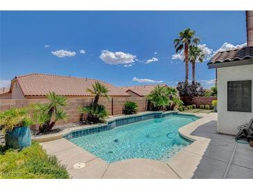 Sparkling pool with mature landscaping and hardscape in backyard provides a tranquil oasis at 10608 Trussell St, Las Vegas, NV 89141