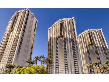 Three tall buildings with palm trees offer a resort-like atmosphere in a city setting at 135 E Harmon Ave # 518, Las Vegas, NV 89109