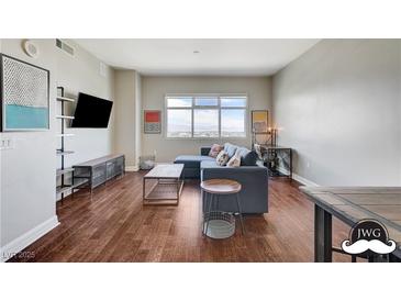 Spacious living room featuring hardwood floors, large windows, and a comfortable sectional sofa at 150 Las Vegas Blvd # 1118, Las Vegas, NV 89101