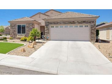Charming single-story home featuring a stone facade, well-manicured landscaping, and a two-car garage at 2545 Nashira St, Henderson, NV 89044