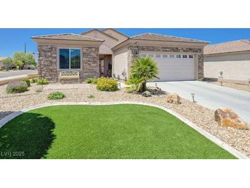 Charming home with a stone facade, well-manicured landscaping and artificial grass at 2545 Nashira St, Henderson, NV 89044
