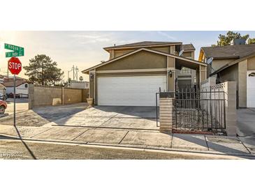 Charming two-story home with a two car garage and gated entry provides privacy and curb appeal at 27 Sirnoble St, Las Vegas, NV 89110