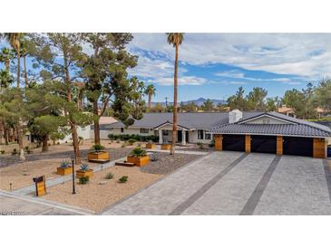 Stunning single-story home with an attached garage and a meticulously landscaped front yard at 3189 Montecito Dr, Las Vegas, NV 89120