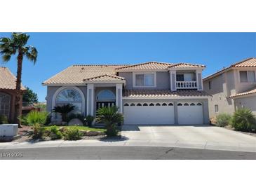 Charming two-story home featuring a three-car garage, tile roof, and landscaped front yard at 3805 White Castle St, Las Vegas, NV 89129