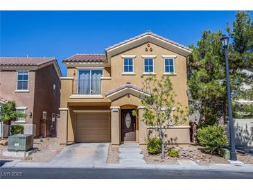 Charming two-story home featuring a balcony, two-car garage, and well-maintained landscaping at 433 Royal Bridge Dr, Las Vegas, NV 89178