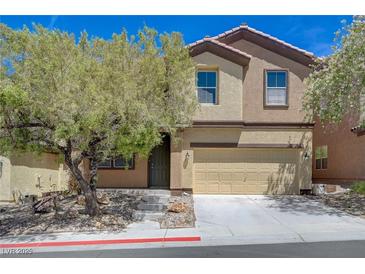 Inviting two-story home featuring neutral stucco, a two car garage, and a manicured front yard at 484 Merseyside Dr, Las Vegas, NV 89178