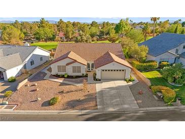 Charming single-story home with a well-manicured front yard, mature landscaping, and a two-car garage at 5009 Elm Grove Dr, Las Vegas, NV 89130