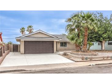 Charming single-story home with desert landscaping, palm trees, and a two-car garage in a residential neighborhood at 516 Donner St, Las Vegas, NV 89107