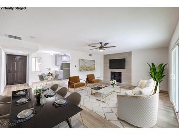 Bright, open-concept living and dining area features stylish furnishings and a modern fireplace at 516 Donner St, Las Vegas, NV 89107