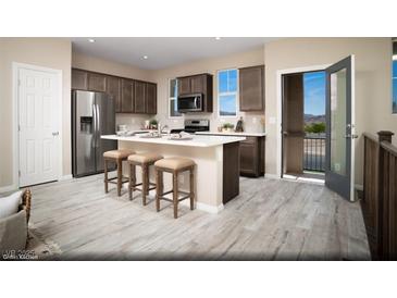 Charming kitchen boasts stainless steel appliances, dark wood cabinetry, and an island with bar stool seating at 627 Bellus Pl # Lot 156, Henderson, NV 89015