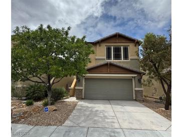 Charming two-story home featuring desert landscaping, a two-car garage, and inviting curb appeal at 6449 Lake Scene St, Las Vegas, NV 89148