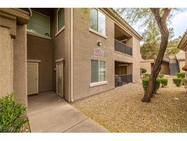 Inviting condo exterior with well-maintained landscaping, neutral tones, and a private entrance at 6655 Flaminian Ln # 104, North Las Vegas, NV 89084