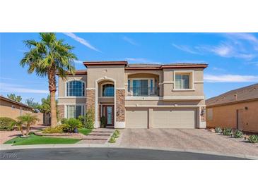 Beautiful two-story home with stone accents, balcony, and three-car garage at 7112 Rancho De Taos Ct, Las Vegas, NV 89130