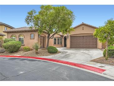 Charming single-story home with desert landscaping, mature trees, and a two-car garage at 7404 Eggshell Dr, North Las Vegas, NV 89084