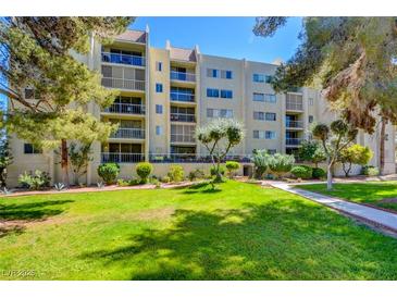 Multi-story condo building featuring balconies and landscaping at 745 N Royal Crest Cir # 127, Las Vegas, NV 89169