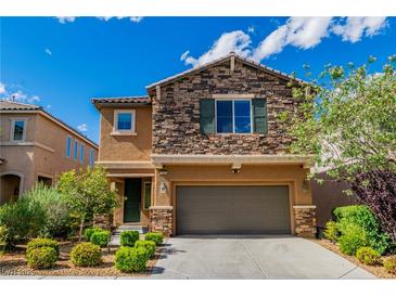 Inviting two-story home with a stone facade and manicured landscaping, plus an attached garage at 7624 Mallard Bay Ave, Las Vegas, NV 89179