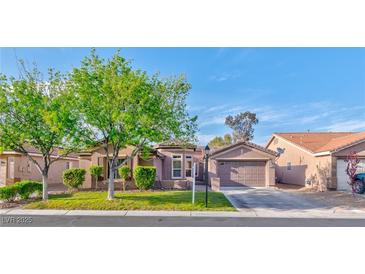 Charming single-story home featuring a lush front yard with mature trees and a well-maintained lawn at 8212 Cabin Springs Ave, Las Vegas, NV 89131
