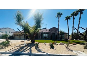Charming single-story home with desert landscaping, palm trees, and a stone entryway at 8225 Fulton Ranch St, Las Vegas, NV 89131