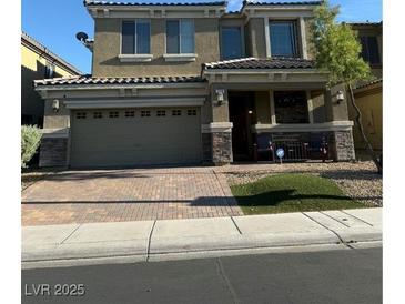 Two-story home featuring a two-car garage, covered entryway, and well-maintained landscaping at 109 Delighted Ave, North Las Vegas, NV 89031
