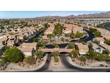 Beautiful Primary-planned community featuring well-manicured lawns, pool, and lush green landscaping at 1185 Via Dimartini, Henderson, NV 89052