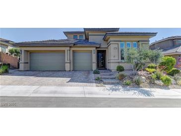 Charming single-story home featuring a three-car garage, beautiful landscaping, and a welcoming entrance at 12318 Tudor Arch Dr, Las Vegas, NV 89138