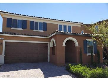 Charming two-story home showcasing its appealing exterior with attached garage and arched entryway at 2580 Sable Ridge St, Henderson, NV 89044