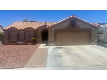 Charming single-story home featuring a desert landscape, barrel tile roof, and two-car garage at 5020 Wildroot Rd, Las Vegas, NV 89130