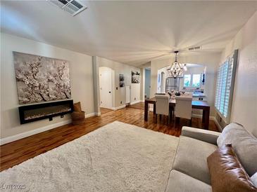 Inviting living room with modern fireplace, wood floors, and cozy furnishings at 6699 Oxendale Ave, Las Vegas, NV 89139