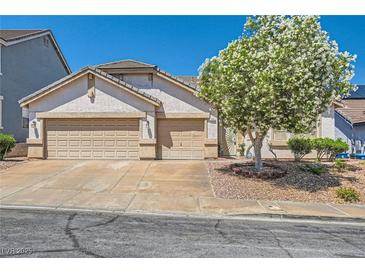 Charming single-story home features a two-car garage and a well-maintained front yard with mature landscaping at 89 Autumn Day St, Henderson, NV 89012