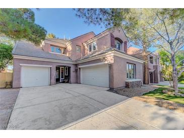 Charming two-story home featuring a three-car garage and a well-manicured lawn with mature trees at 9704 Royal Lamb Dr, Las Vegas, NV 89145